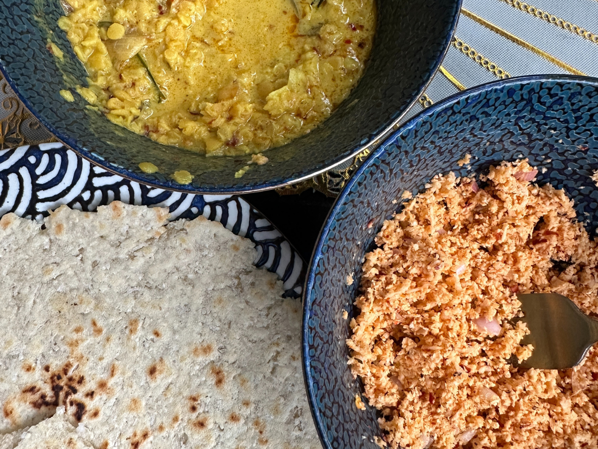 A trio of Sri Lankan dishes, coconut relish (pol sambol), yellow lentil curry (dal), pol roti (coconut flatbread)