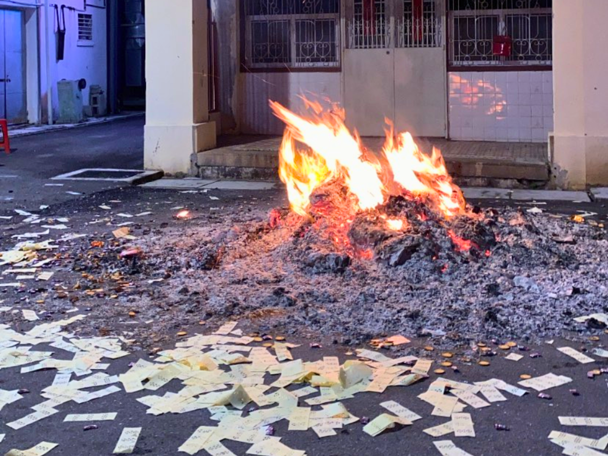Piles of fake money (joss paper) being burned as an offering for ancestor spirits and ghosts during Malaysia’s Hungry Ghost Festival