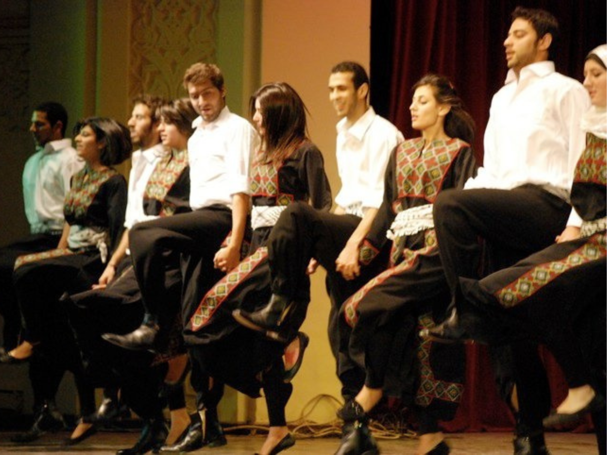 A troupe of Levantine men and women performing dabkeh, a traditional Levantine line dance