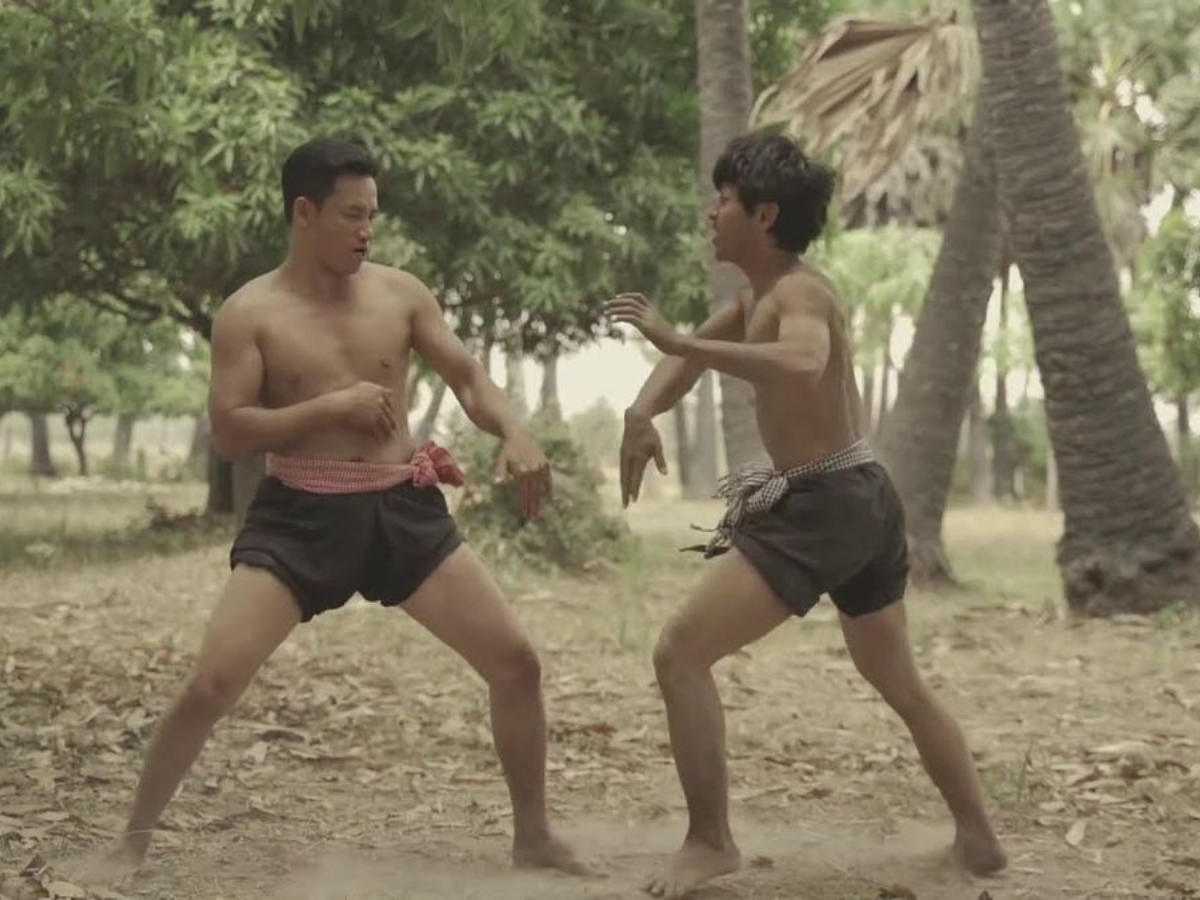 Cambodian men wearing kramas, engaging in traditional Khmer Bokator martial art fighting