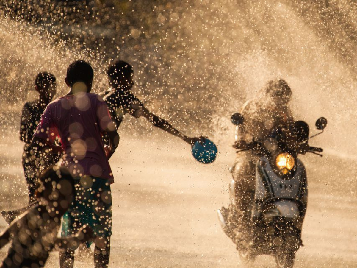 Children splashing passersby with water during Cambodia’s famous Chaul Chnam Thmey water fights