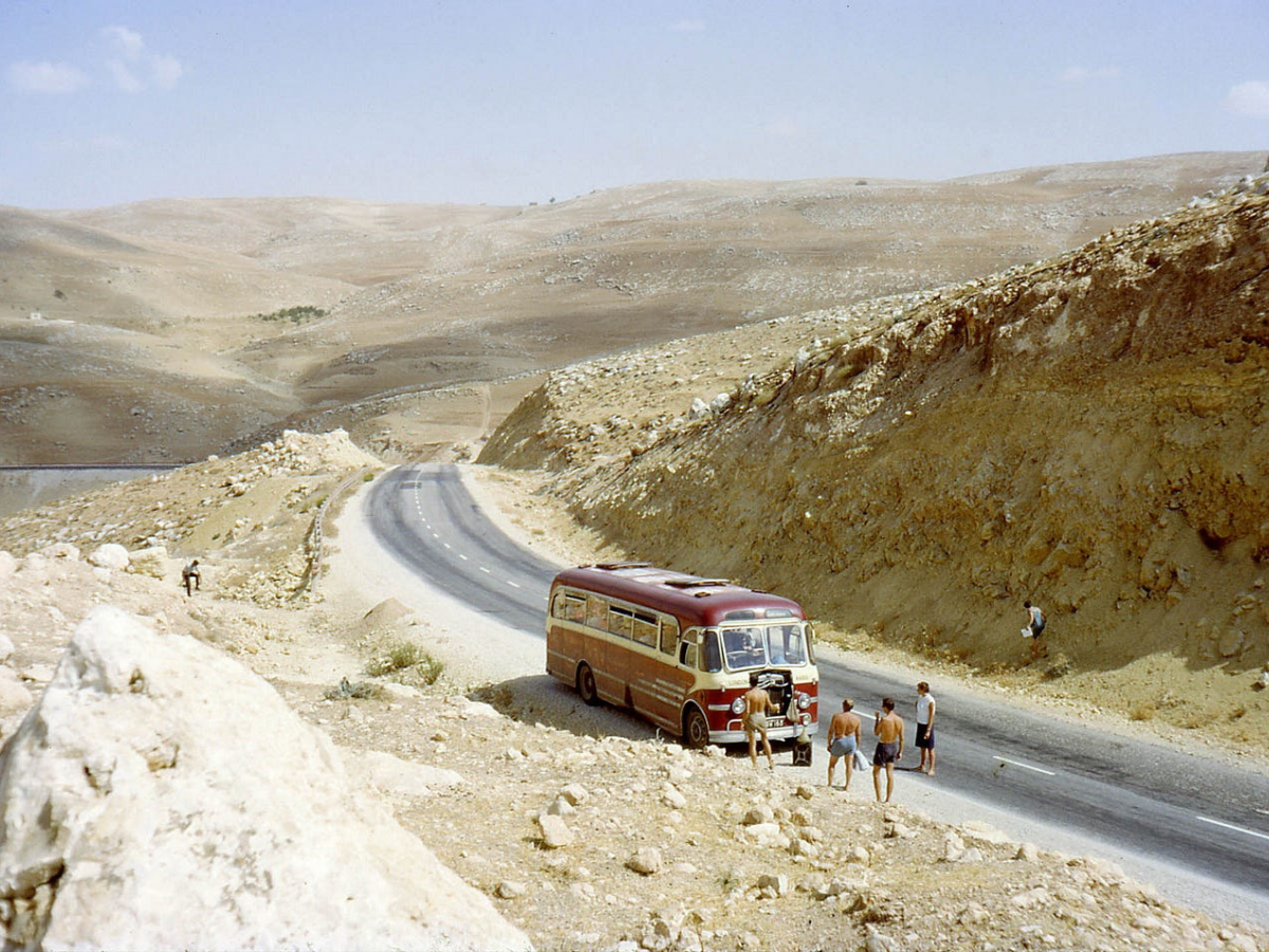Vintage photo of one of the many buses that transported young travelers through the Hippie Trail routes, stopped in Jordan