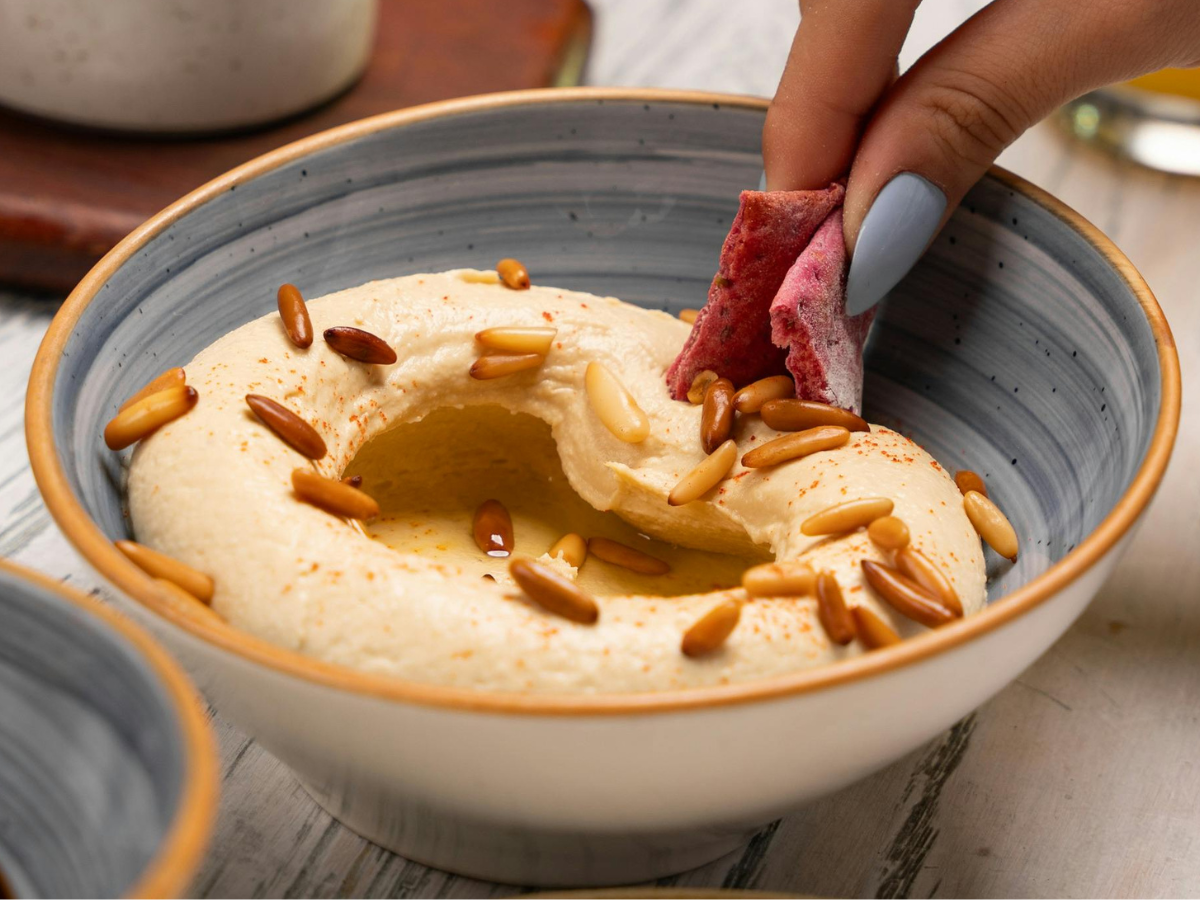 Chickpea hummus, often served with pine seeds and olive oil, is one of the most popular Levantine mezze dishes
